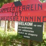 sign at the entrance of the campsite, stating it is an antimlitarist, alcohol- and drugfree place.