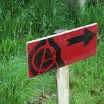 a signpost with a circled A